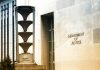 Department of Justice building exterior with column and sign.