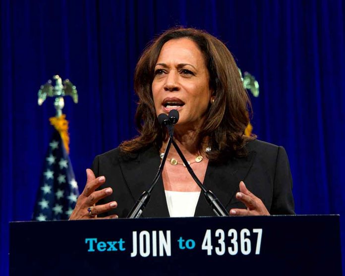 Woman speaking behind a podium with blue backdrop.