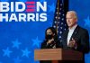 Two people speaking at a "Biden Harris" event.