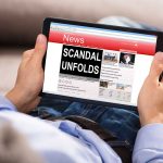 Person reading tablet with headline "Scandal Unfolds".