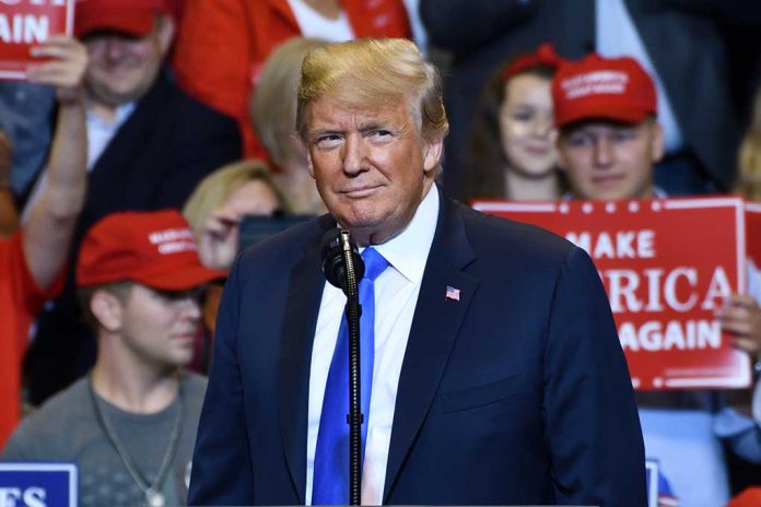 Person at a rally with Make America Great Again signs.