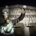 Blindfolded Lady Justice with scales, Supreme Court background.