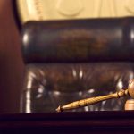 Judge's gavel and chair in court room.