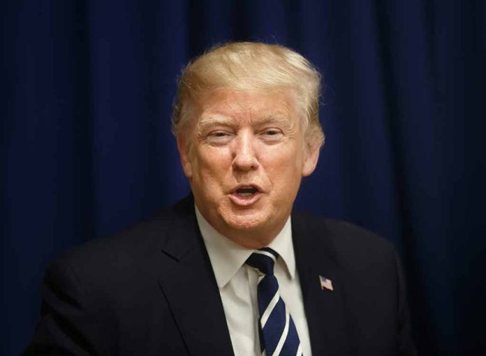 Man in suit with striped tie speaking.