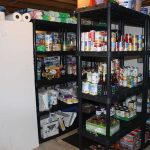 Shelves stocked with canned goods and household supplies.