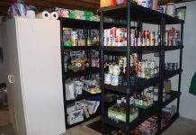 Shelves stocked with canned goods and household supplies.