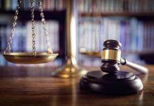 Gavel and scales of justice on desk.