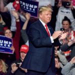 Person clapping at a political rally event.