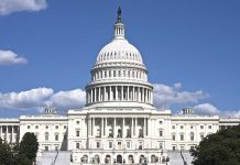 U.S. Capitol building against blue sky.