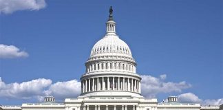 U.S. Capitol building against blue sky.