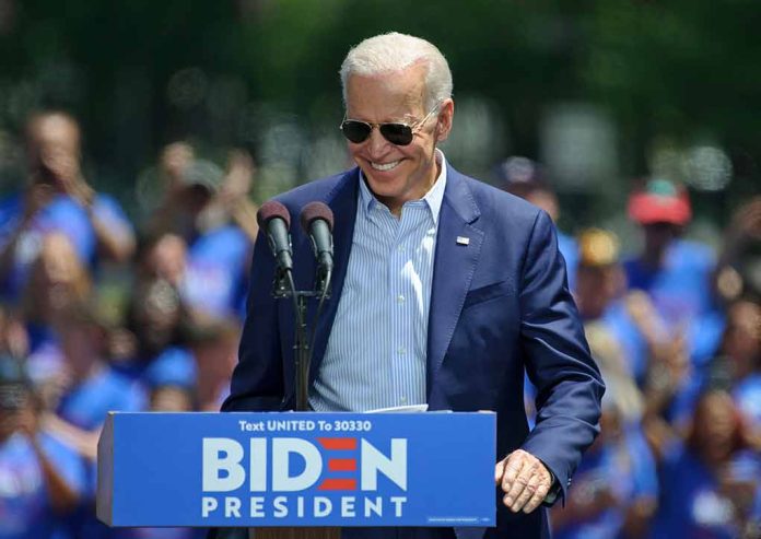 Man speaking at outdoor campaign event with sunglasses