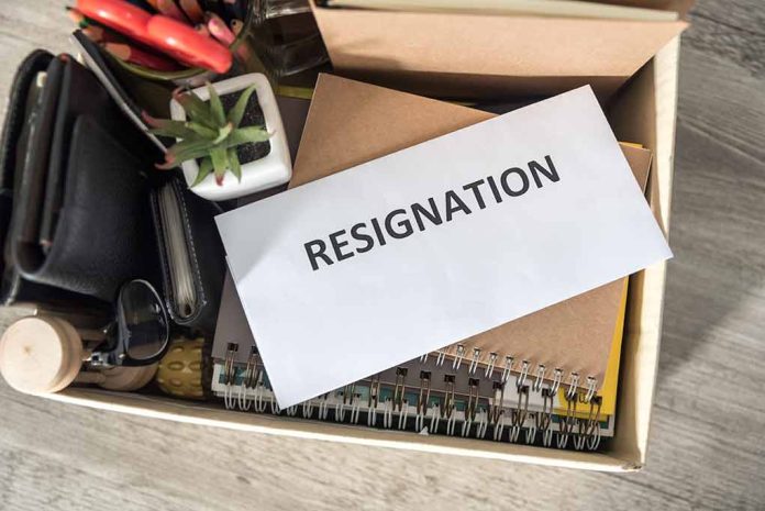 Envelope labeled resignation in a box of office items.