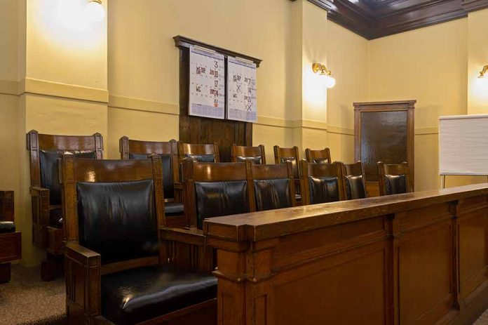 Empty courtroom jury seats with wood paneling.