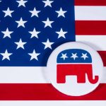 Republican elephant button on American flag background.