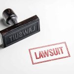 Rubber stamp with the word lawsuit on paper