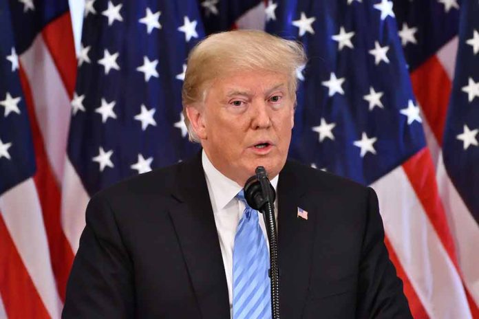 Man speaking at podium with American flags behind