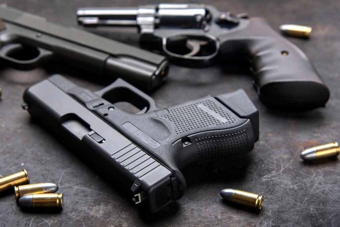 Three handguns with bullets on a metal surface