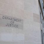Department of Justice building with American flags.