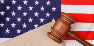 Gavel on American flag with blank paper