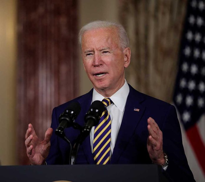 Man speaking at podium with microphones and flag background