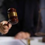 Gavel being struck by a judge in courtroom.