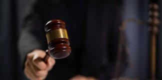 Gavel being struck by a judge in courtroom.