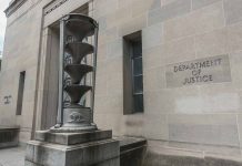 Department of Justice building with sculpture outside.