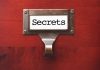 Label holder with the word "Secrets" on red background.