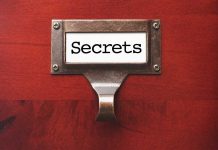 Label holder with the word "Secrets" on red background.