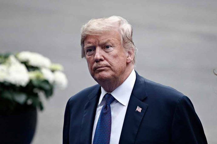 Man in a suit with an American flag pin.