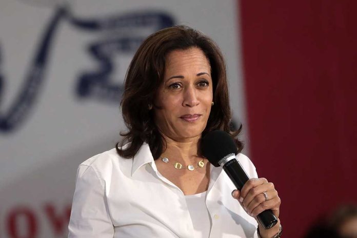 Woman holding a microphone and speaking on stage.