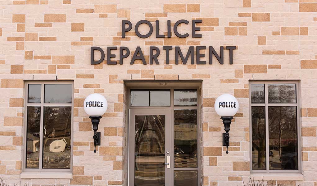 Police department building with brick exterior and signage.
