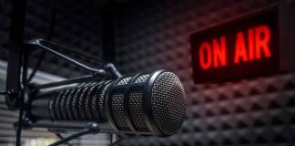 Microphone in studio with On Air sign.