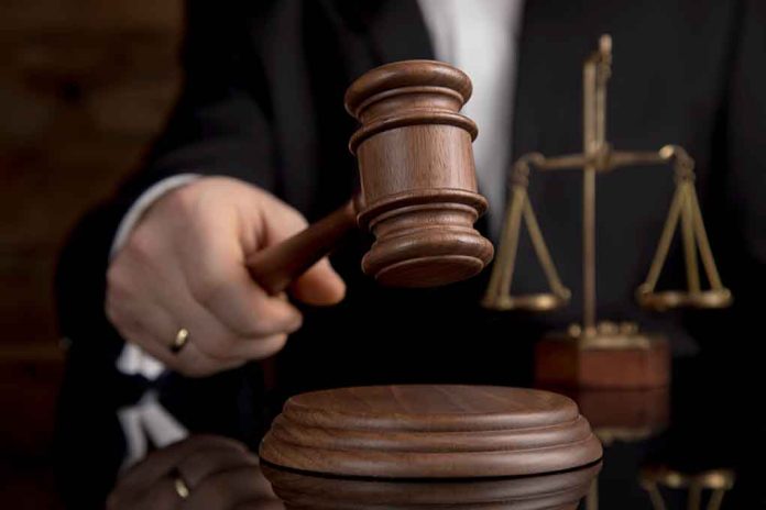 1352202980 featured image Judge with gavel and scales of justice behind.