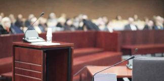 Empty courtroom with microphones and a podium