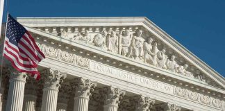 US Supreme Court building with American flag