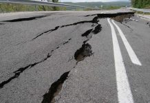 Road damaged by significant cracks and fissures.