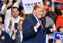 Man in suit standing at a rally event