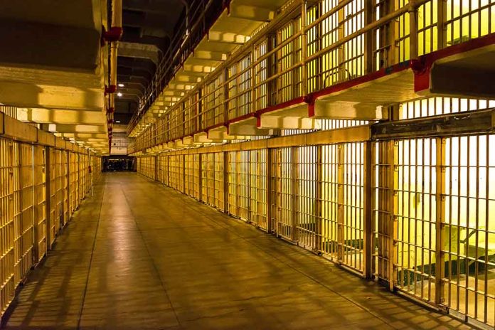 1231860007 featured image Empty hallway between rows of prison cells