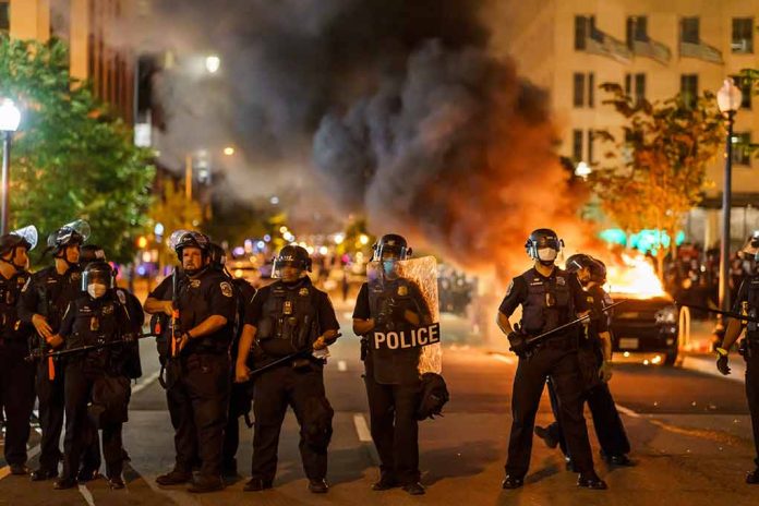 1796220283 featured image Police officers in riot gear near burning car