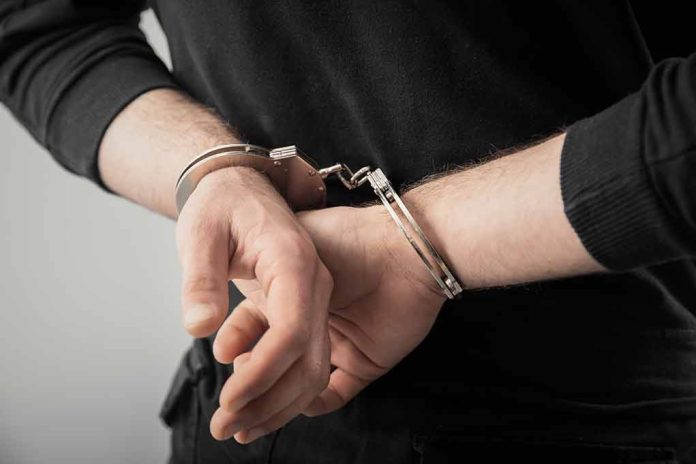 1939458211 featured image Hands in handcuffs behind back.