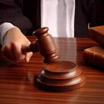 Judge gavel on desk with books