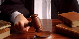 Judge gavel on desk with books