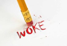 Pencil erasing the word woke in red.