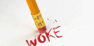 Pencil erasing the word woke in red.