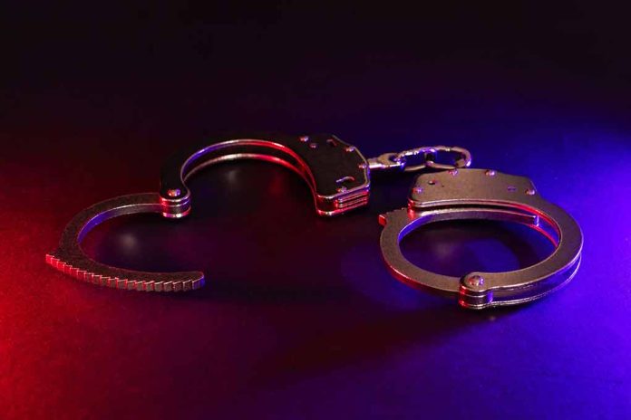 2423548283 featured image Handcuffs with red and blue dramatic lighting.