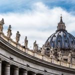 St Peter Basilica dome with statues and clouds
