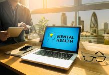 Laptop displaying "Mental Health" screen in an office.