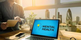 Laptop displaying "Mental Health" screen in an office.