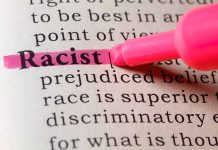 "Racist" highlighted in pink marker in a book.